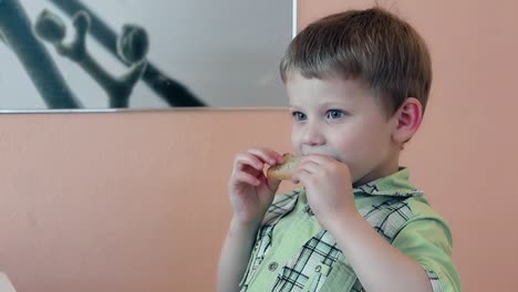 child takes a plate of fried bread