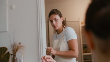 woman in apron talking in a kitchen
