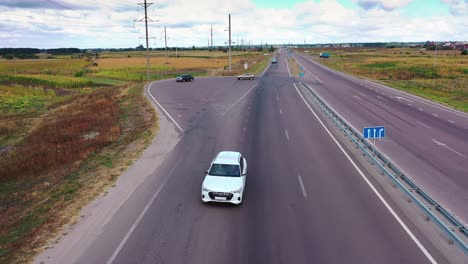 drone shot on highway. wide shot aerial drone view tracking car on empty road