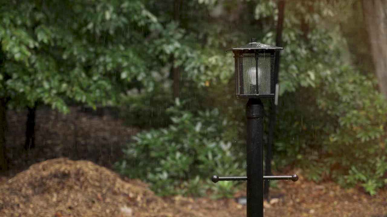 Rain cascading down from rough clouds. Static sad shot.