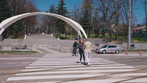 couple walking at crosswalk. lovers man and woman cross road in city center