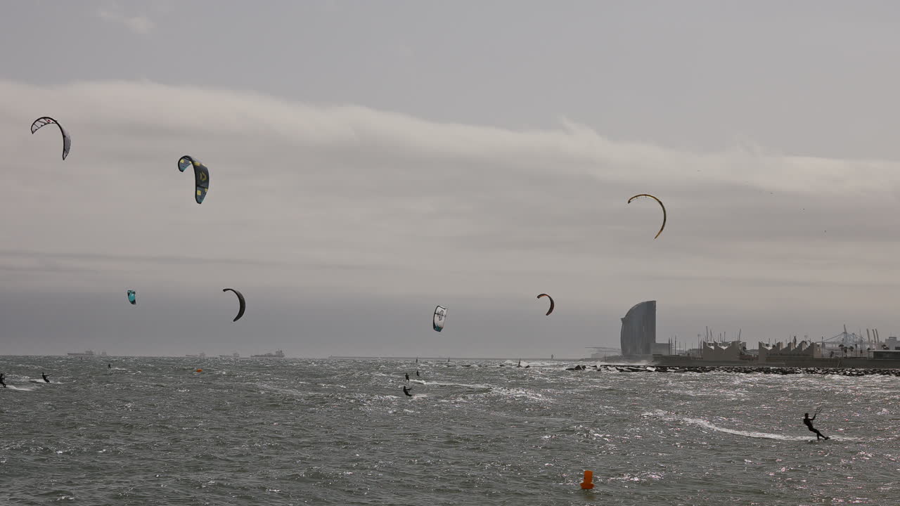 Kitesurfers on a windy day at sea in barcelona