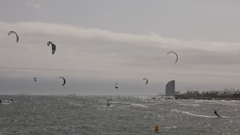 kitesurfers on a windy day at sea in barcelona