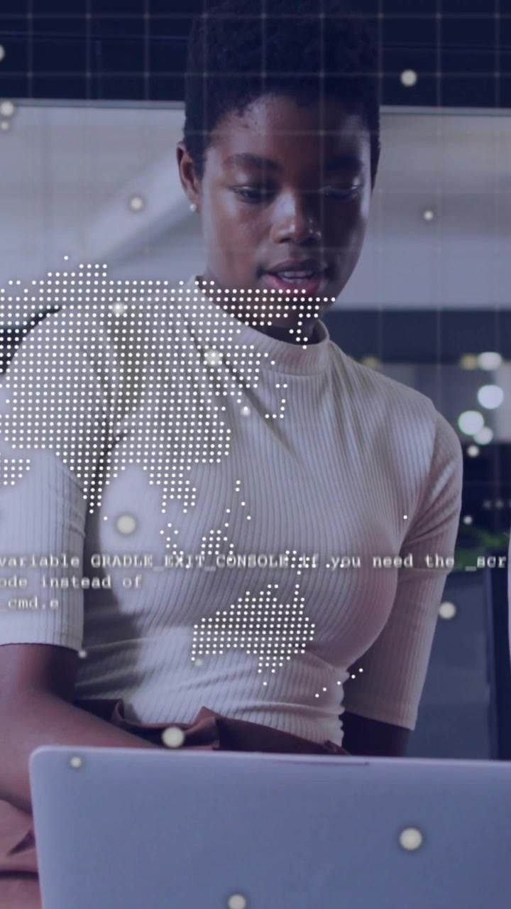 Vertical video: Woman shifting gaze to laptop leaning reading typing dot map on face for tech work