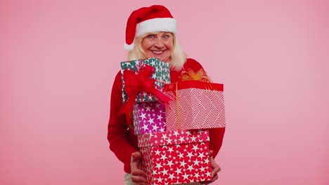 Grandmother-old-woman-in-Christmas-Santa-sweater-holding-many-gift-boxes-New-Year-presents-shopping