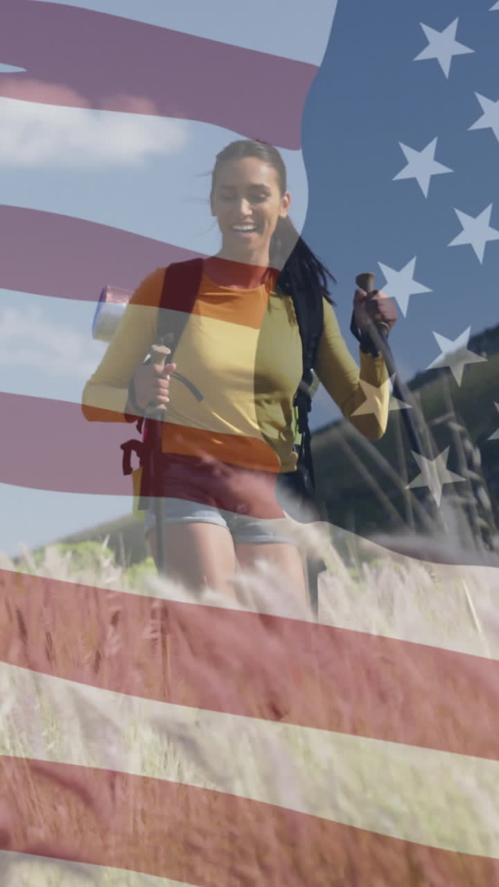 animación de la bandera estadounidense sobre una pareja diversa sonriente caminando en las montañas