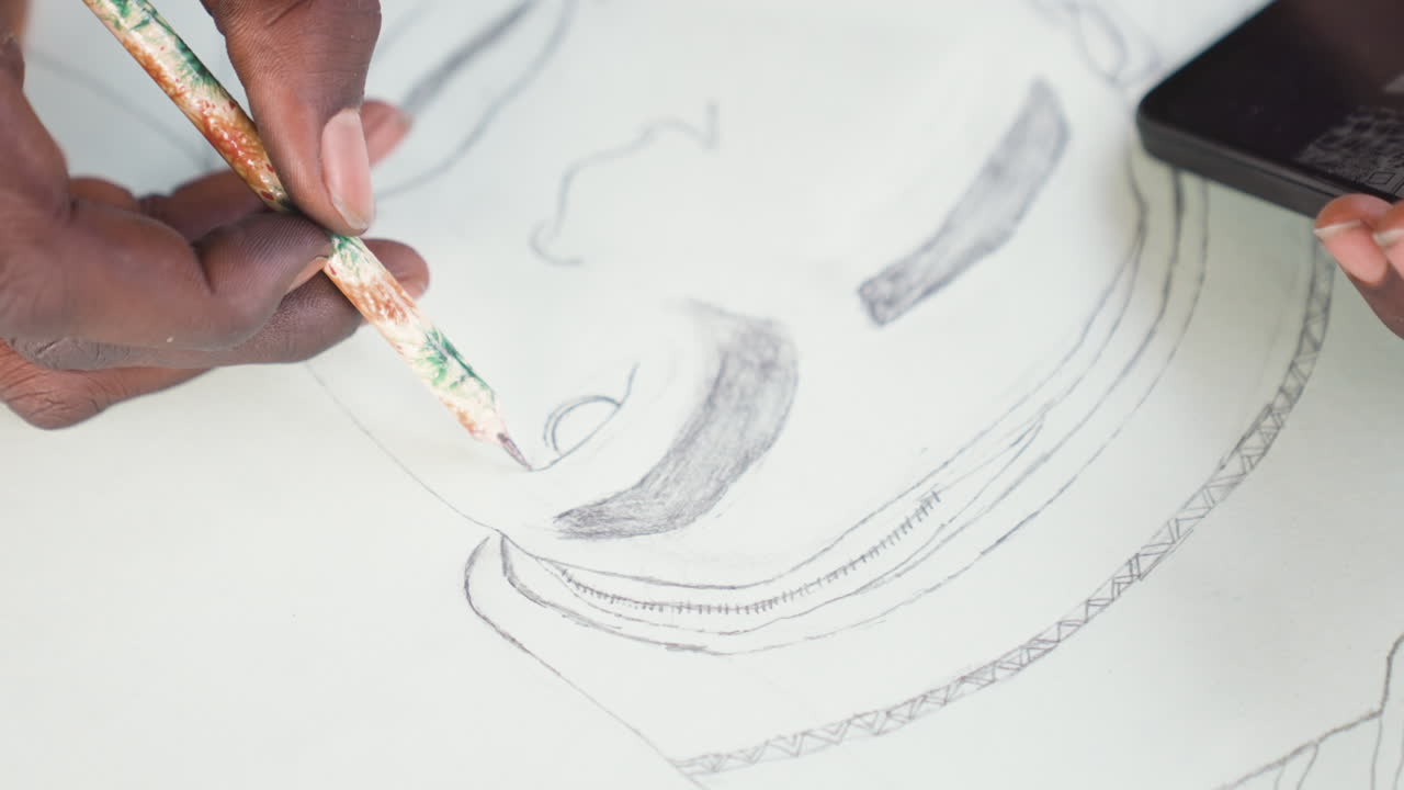 Hands draw portrait. Sketching face with textured shading. Fingers craft detailed portrait with pencil strokes. Closeup of hands creating textured portrait on paper while using smartphone