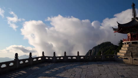 traditional pagoda on a mountain peak amidst a sea of clouds