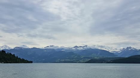 Static-time-lapse-shot-of-Swiss-mountain-and-lake-during-overcast-day