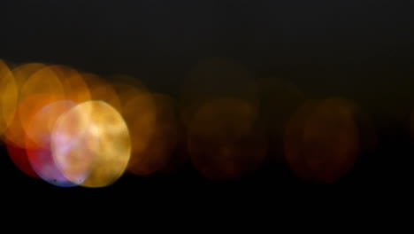 animation of christmas fairy lights flickering over black background