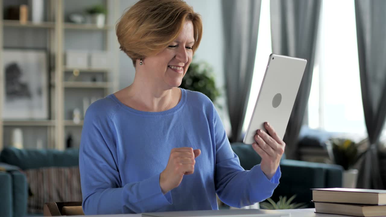 Old Senior Woman Celebrating Success while Using Tablet
