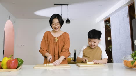 mom and boy cutting bananas.