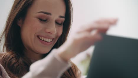 Brunette-woman-waving-hand-to-laptop-screen.-Video-conversation-online