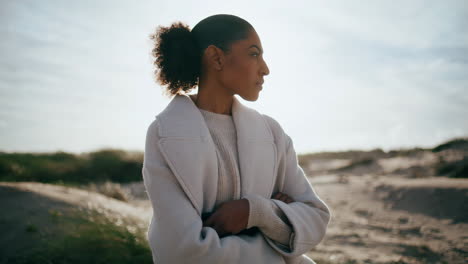 thoughtful woman look distance rest on beach. worried black hair girl consider