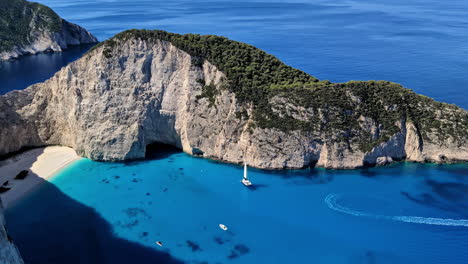 Panoramic-view-of-Navagio-beach-in-Greece-with-boats-on-a-sunny-summer-day