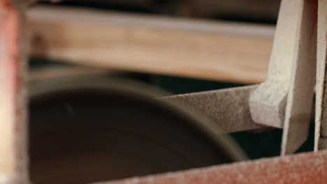 wooden billets sawed with circular saw on automated production line at sawmill