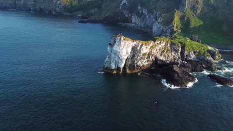 Kinbane-Castle-in-County-Antrim,-Northern-Ireland,-on-a-long,-narrow-limestone-headland-projecting-into-the-sea,-revealing-drone-shot