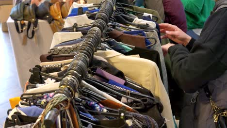 a customer is looking at clothes hanging on a hanger