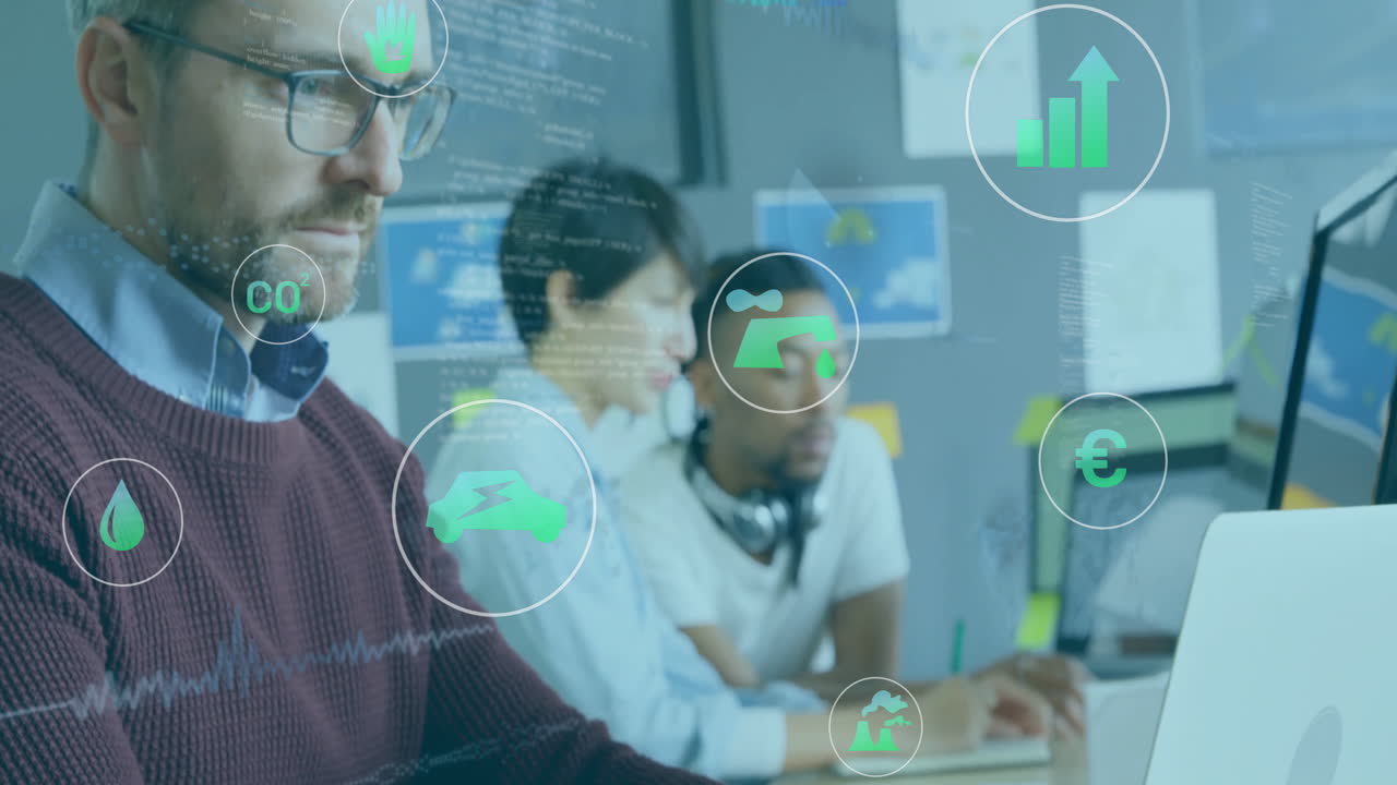 Working at computers, diverse team with animation of environmental data icons