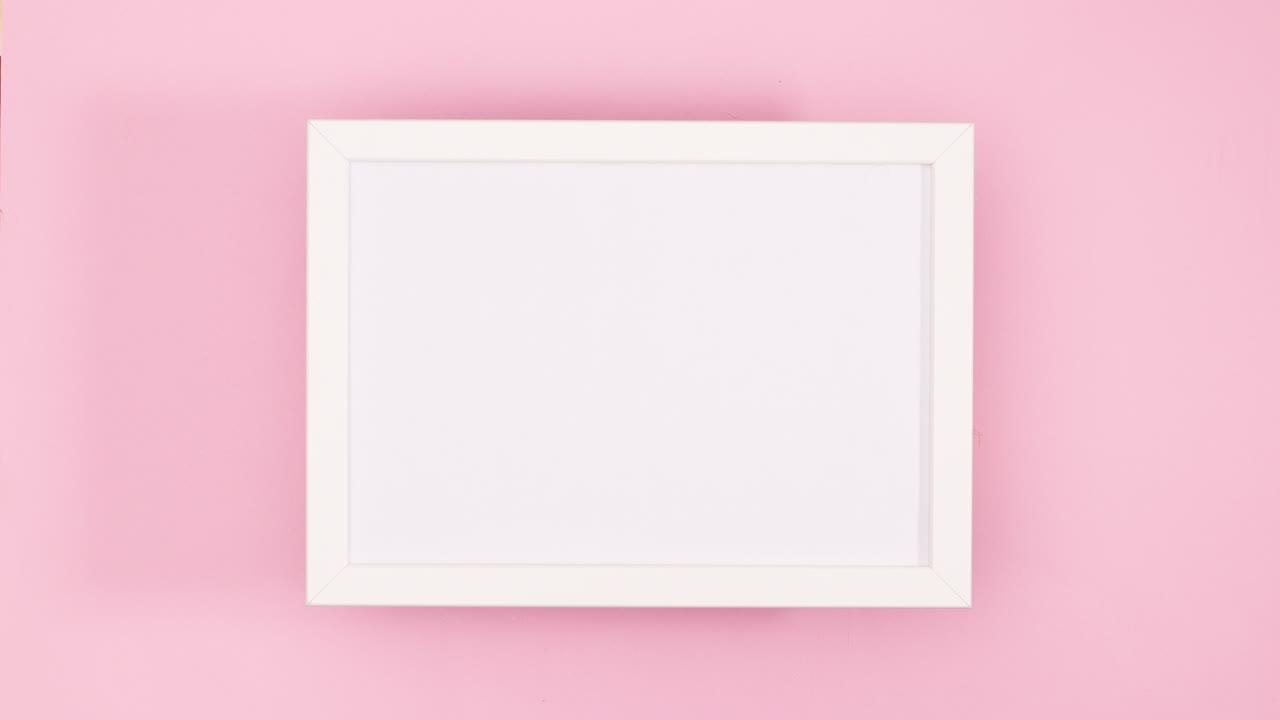 Gold Christmas ornaments and stars appear under white frame for text on pastel pink theme .Stop motion