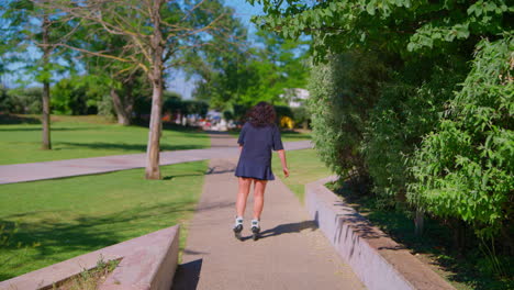 woman rollerblading in a park on a sunny day