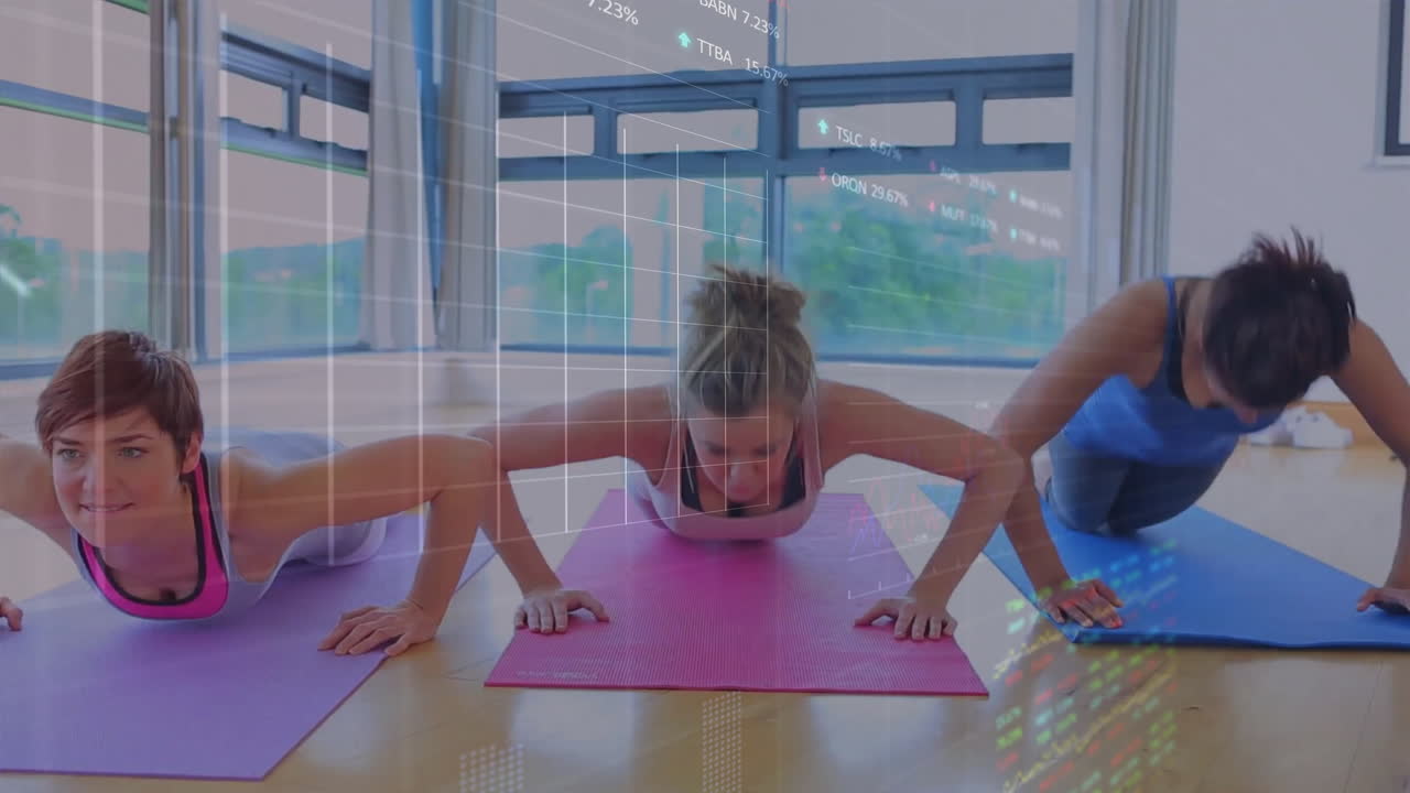 Three women performing push-ups in fitness studio, with animated stock-market data grid overlay