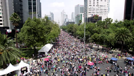 frontal-drone-shot-of-pride-parade-stands-in-paseo-de-la-reforma-avenue-at-mexico-city