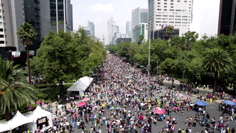 frontal drone shot of pride parade stands in paseo de la reforma avenue at mexico city