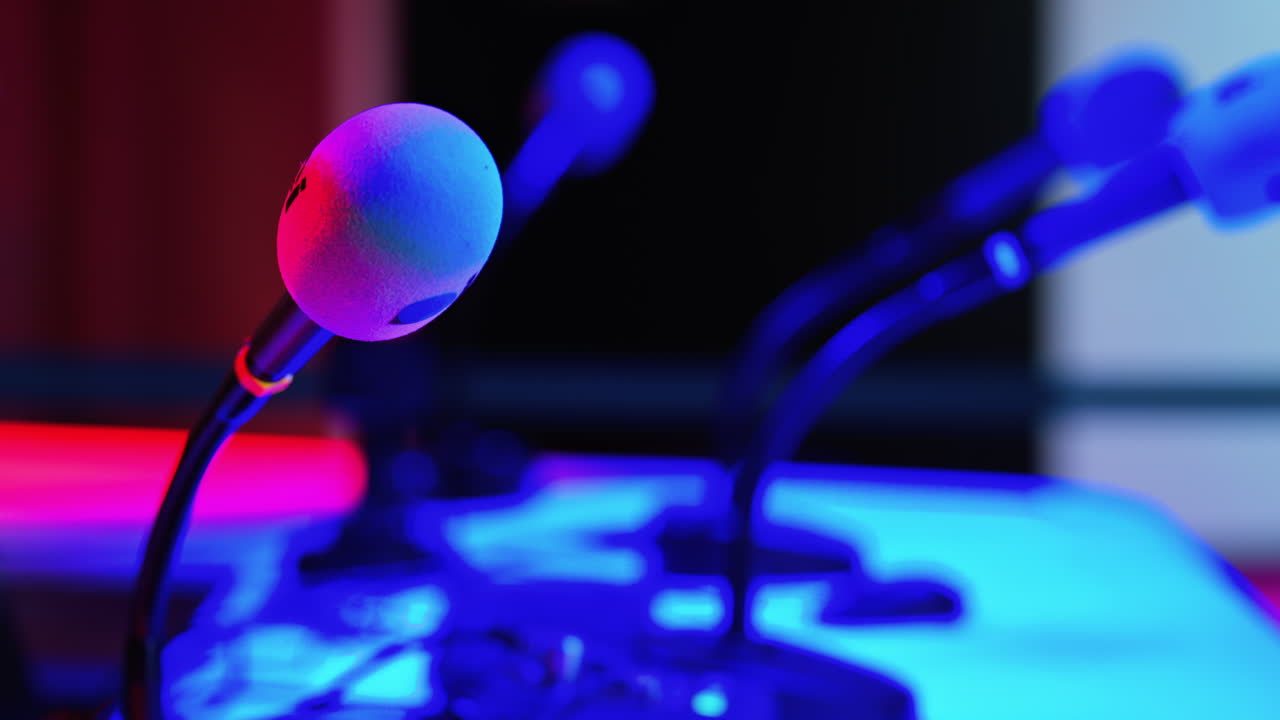 Close up of a microphone on a blurred background with blue and red lights at the International Games Festival in Cannes, France