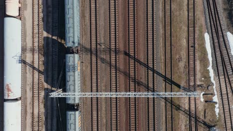 aerial: top down view of empty cargo train parked on train rails