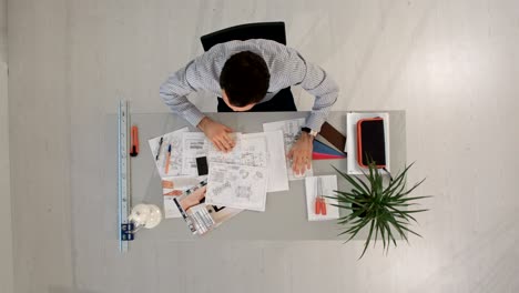 desperate businessman in his office looking down. top view