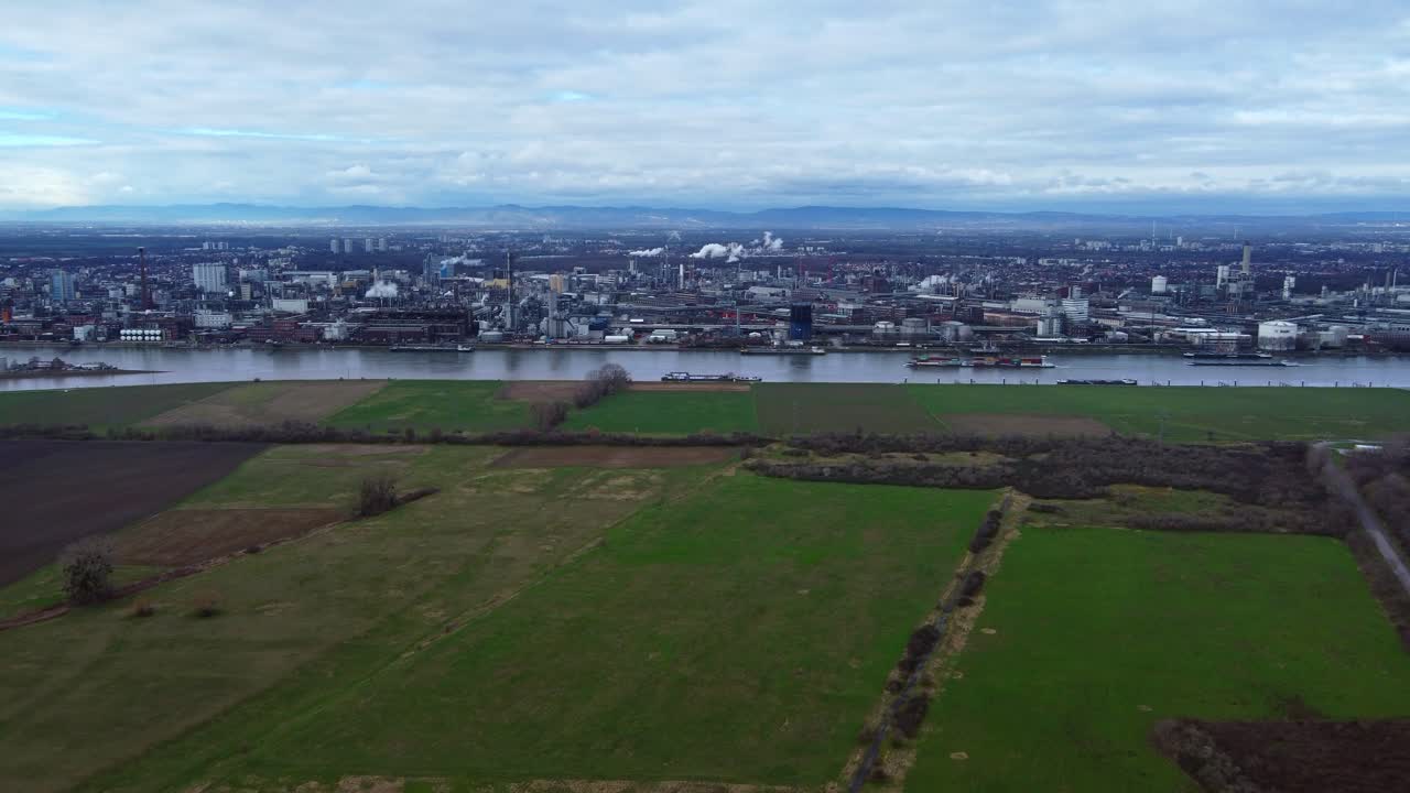 Ships leaving river port of large chemical industry Complex loaded with cargo, Drone wide dolly in