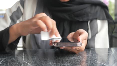 woman cleaning her smartphone