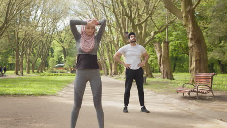 couple exercising in a park