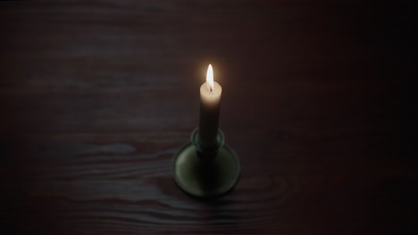 a candle burs out in the dark room