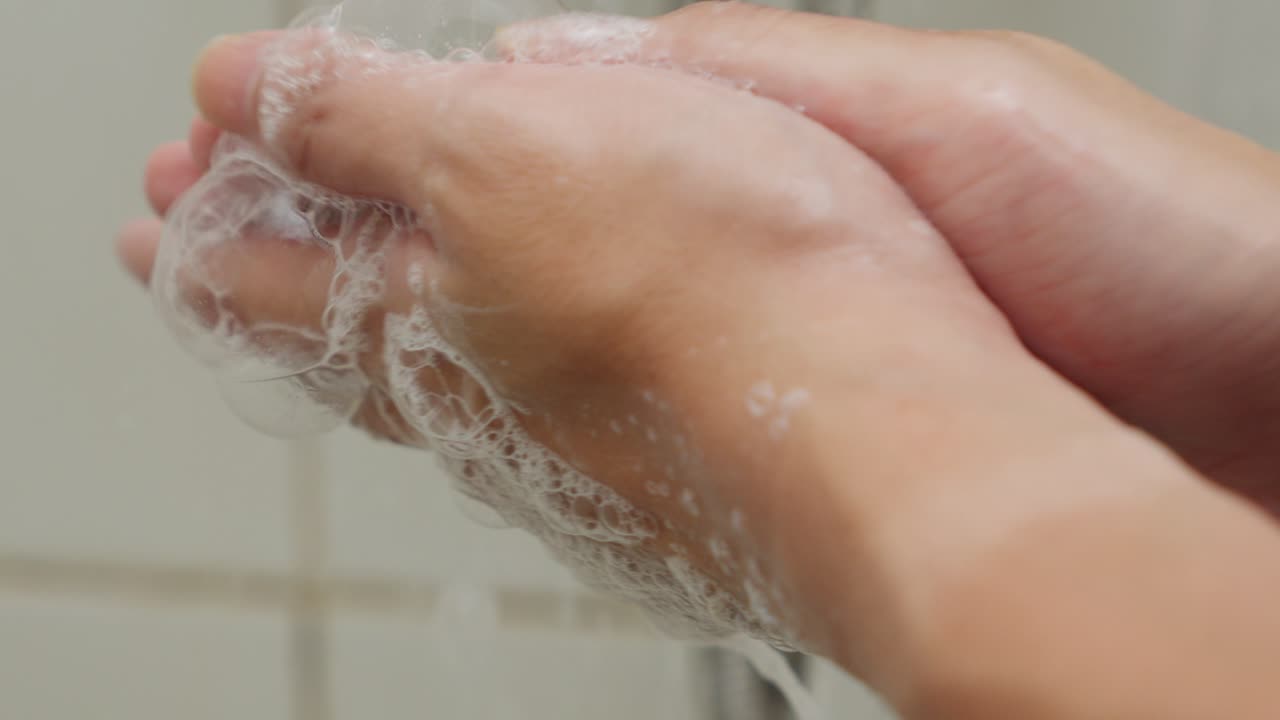 Washing Hands Gently With Soap and Water In Bathroom Then Rinse Foam Bubbles, Close Up