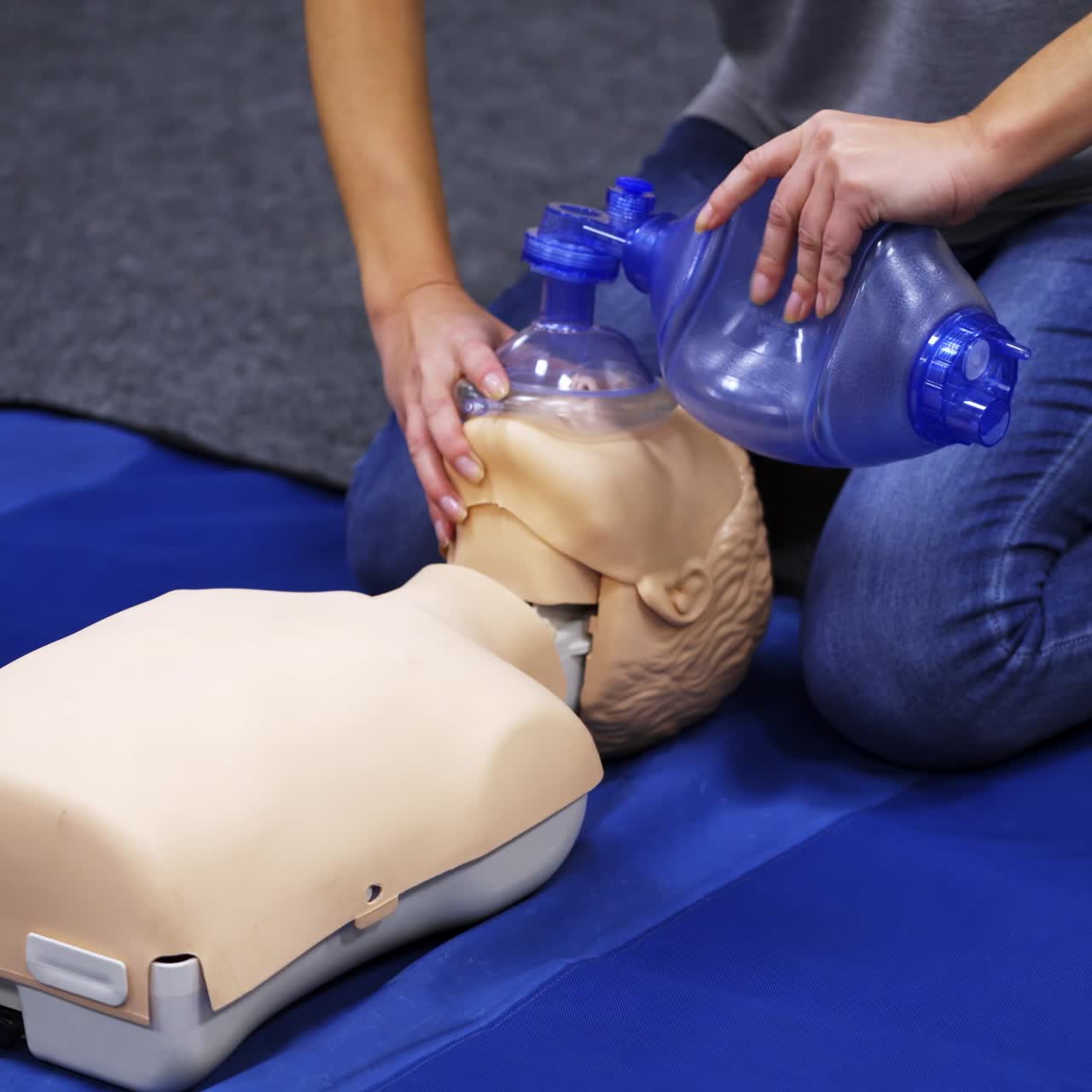 Cardiopulmonary resuscitation. Instructor demonstrates first aid reanimation on a dummy. Medical worker shows cardiac exercise on a mannequin