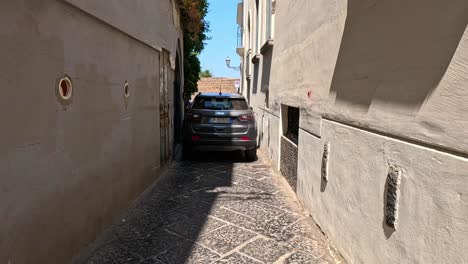 vehicles navigating a narrow alley in sorrento