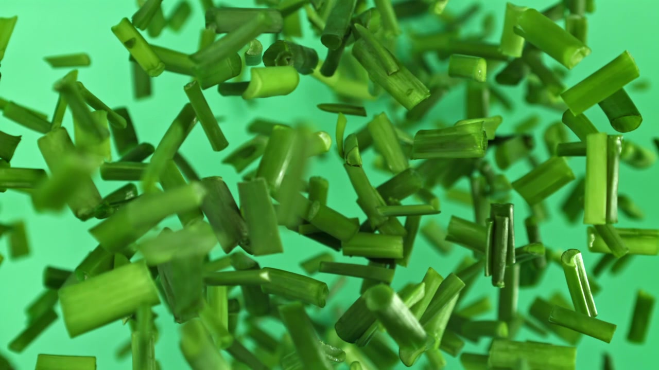 Vibrant Green Chopped Chives Falling in Slow Motion