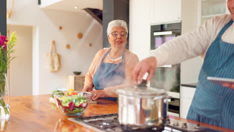 elderly couple cooking together