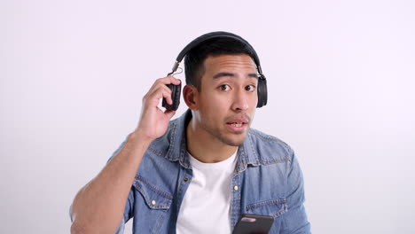 man wearing headphones and looking surprised