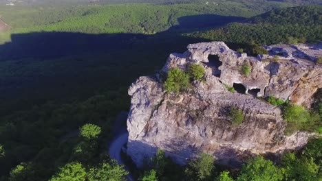 aerial view of a mountainous rock formation with caves