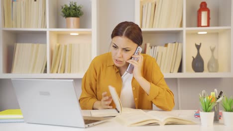 Female-student-speaking-angrily-on-the-phone.