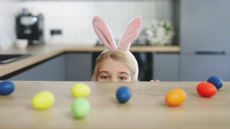 Child Hiding Behind Counter Looking at Easter Eggs