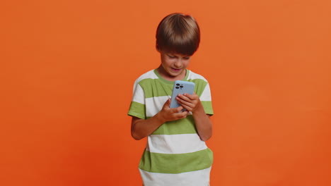 child boy kid use mobile smartphone browsing say wow yes found out great win good news celebrate