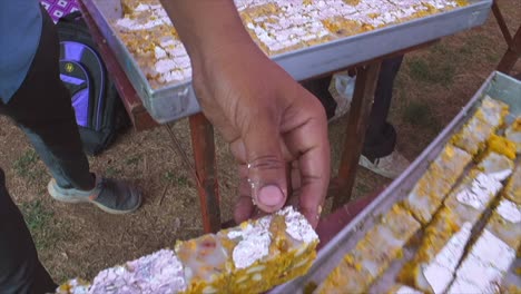 indian-sweets-making-and-sweets-placed-empty-rectangle-tray-closeup-view