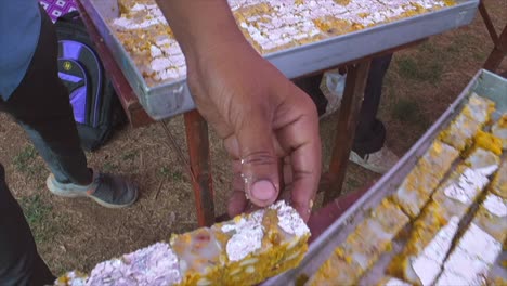 indian sweets making and sweets placed empty rectangle tray closeup view