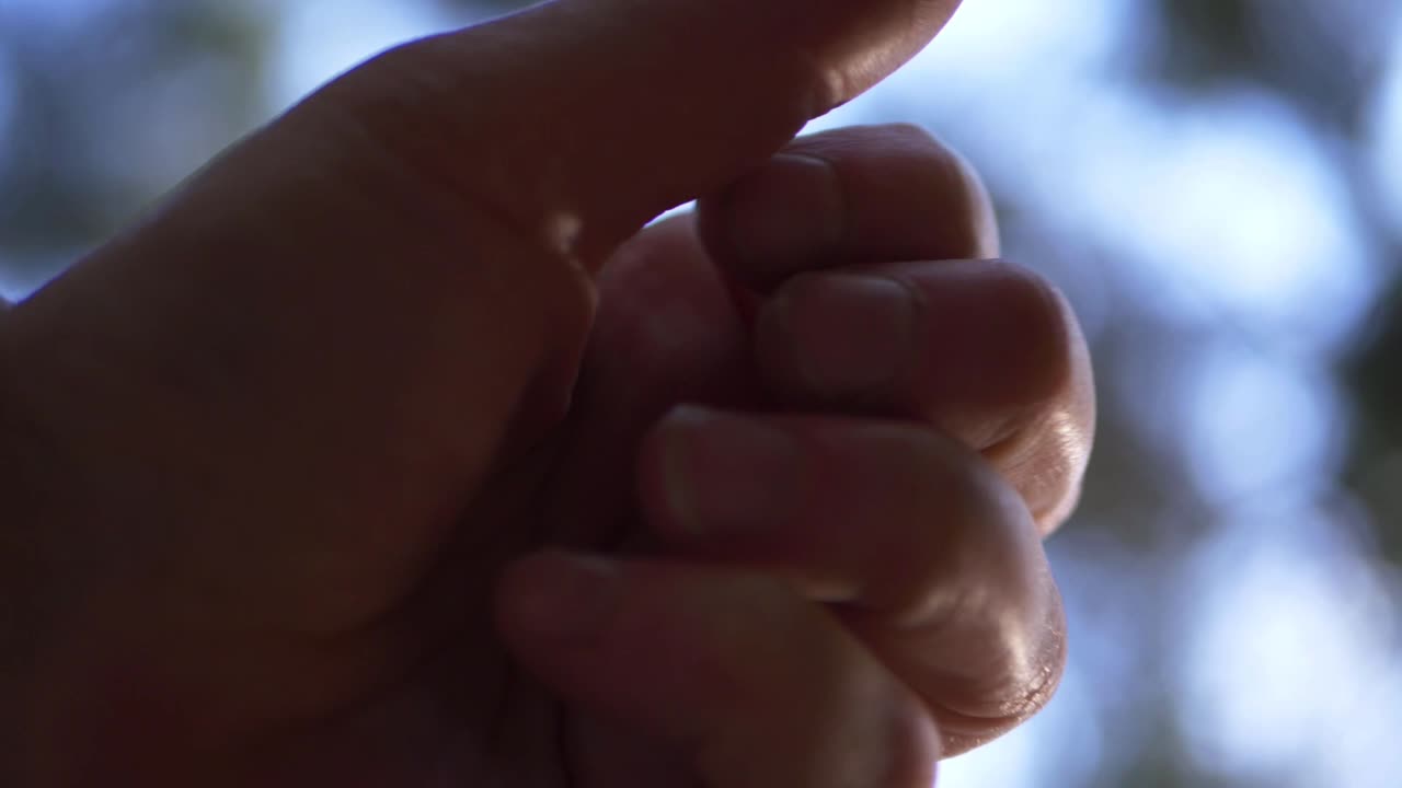 Single hand opening out against bokeh lights background close up shot