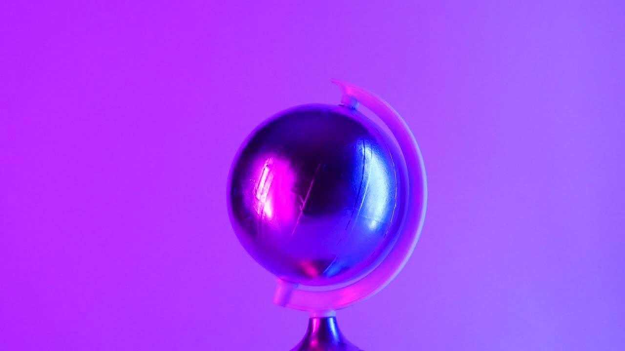 Sci fi futuristic gold globe rotating with cyber punk light effects on pink background