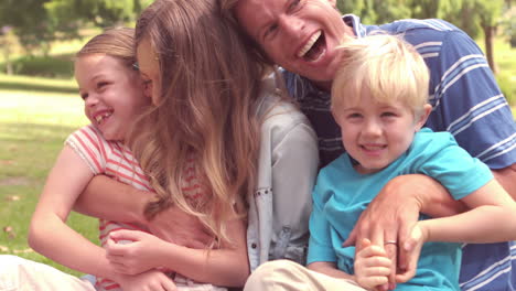 happy family laughing in a park